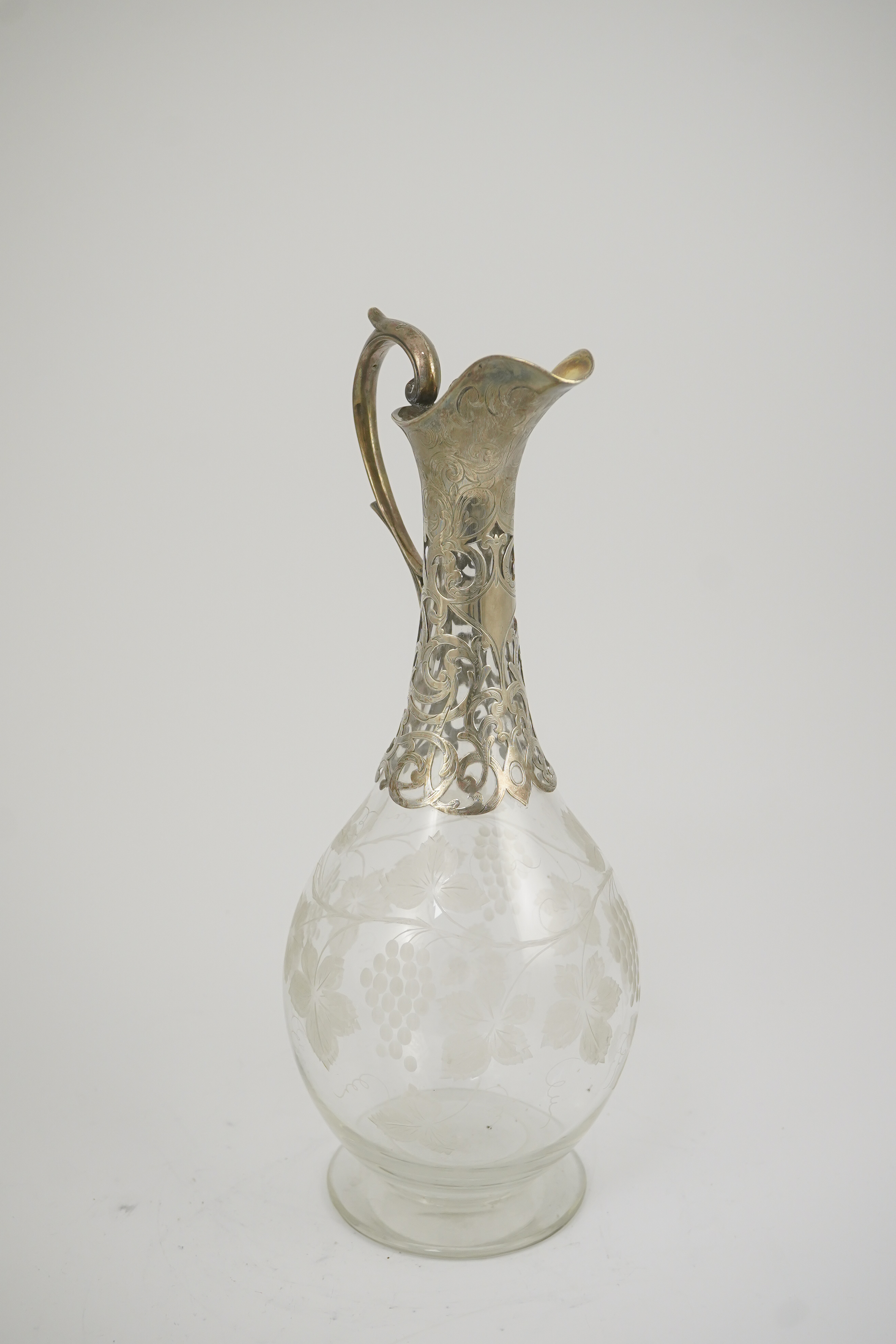 A Victorian parcel gilt silver mounted glass pyriform claret jug, by Joseph Angell II